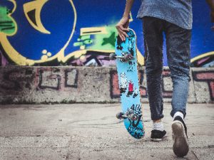 A teenager is poised to display his tricks on the street