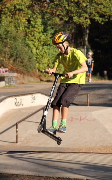 trick scooters can be hard to master especially for this little kid with his helmet, but it is definitely possible when you put in the time and effort