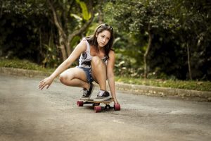 A girl performing a trick while seated, demonstrating balance, timing, and respect for others' space.