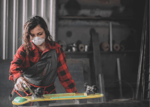 Woman lubricating her skateboard