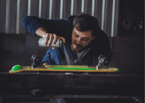 Man lubricating his board