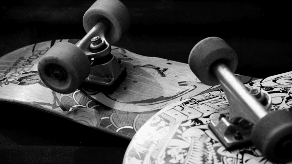 The picture is black & white and features two waxed skateboards.