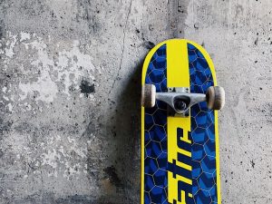 A blue and yellow board leaning against the wall.