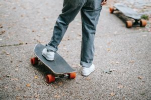 very cute black longboard with rider's foot on