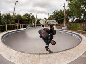 A man doing a backflip and trying to master the trick by practicing tirelessly.