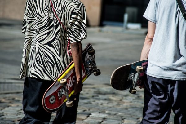 2 skateboarders on their way to the park