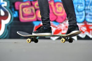 Feet on a skateboard with smooth and adjusted parts