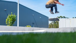 A guy doing skateboard stunts at the park. 