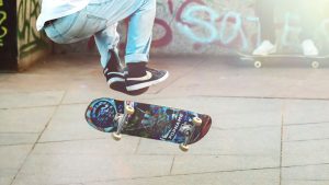 A picture of a person's half body doing longboard stunts. 