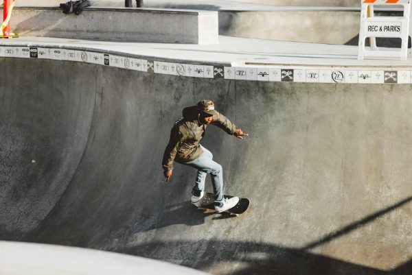 A man doing tricks confidently using his skateboard