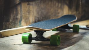 Skateboard Accessories: A skateboard with green wheels