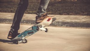 Skater riding skateboard with skateboard shoes without skateboard guide