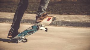 A skater riding a skateboard with his skateboard shoes without any skateboard guide