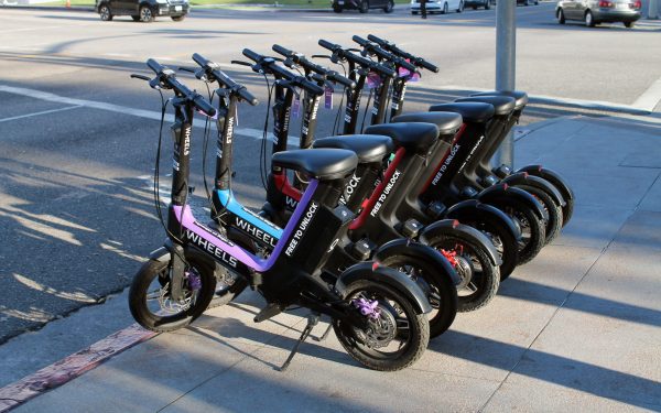 Seven scooters are parked for display.