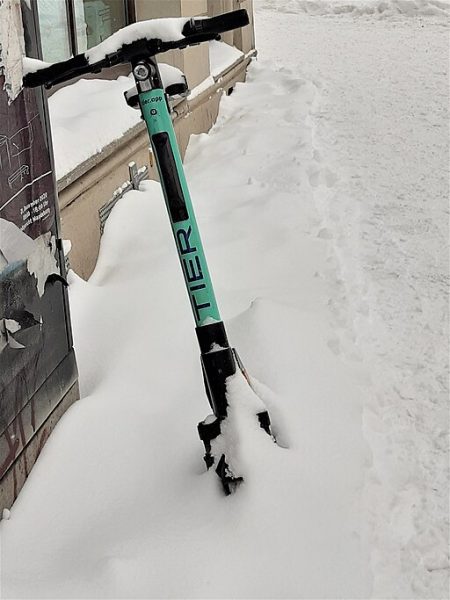 e-scooter covered in built-up flakes during winter season