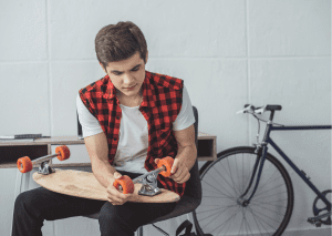 Skateboards: Wheels of a skateboard being inspected on another skateboard.