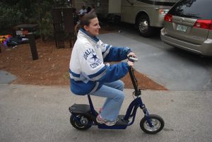 A woman with a seated electric scooter