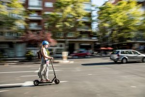 Woman riding one of the top electric scooters while commuting. 