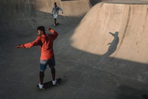 Two men playing at a skatepark.
