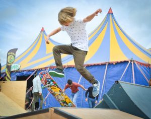 Skateboarders doing tricks at a community park.