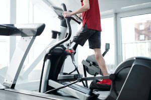 guy in red on an elliptical - a challenging workout but not to overwork the leg muscles.