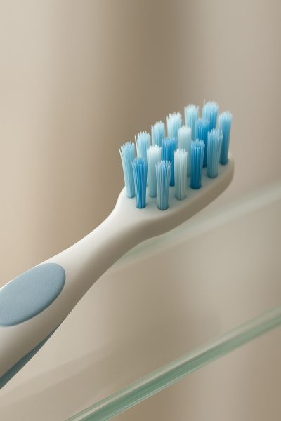 Extreme close-up of a premium manual toothbrush with advanced bristle technology and contoured ergonomic handle.