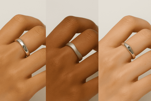 Anxiety rings of various metals and gemstones on hands with diverse skin tones, showing finish and fit.