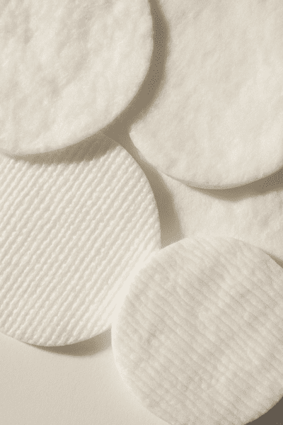 Macro view of cotton pads highlighting fiber details and absorbency differences.