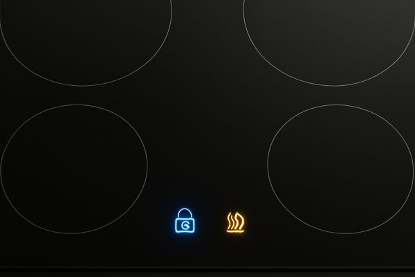 Spotless glass-ceramic induction cooktop with illuminated safety icons.