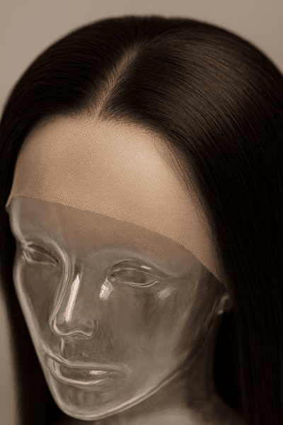Macro image of a full lace human hair wig on a clear mannequin, highlighting lace weave, hairline detail, and density.